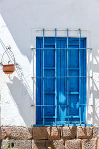 Closed blue door of house on sunny day