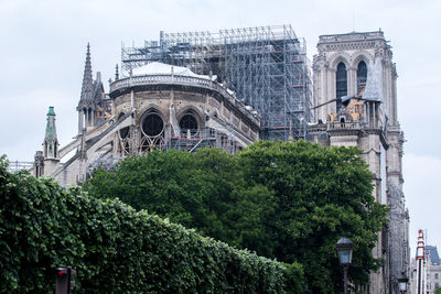 View of historic building notre dame against sky after fire 