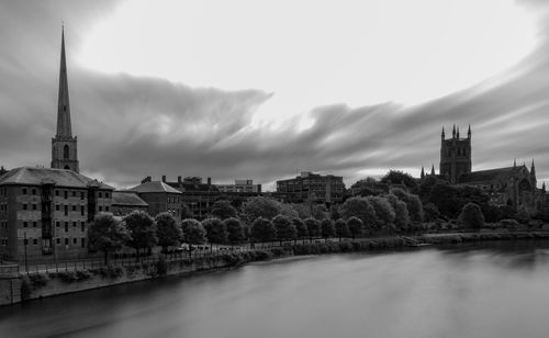 River amidst buildings against sky in city