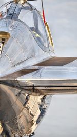 Airplane on airport runway against sky