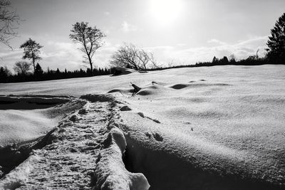 Scenic view of snow covered land against sky