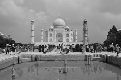 Tourists at monument against sky