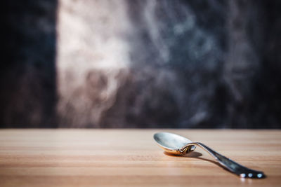Close-up of spoon on wooden table