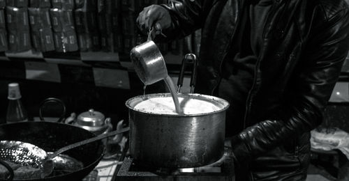 Midsection of man preparing tea