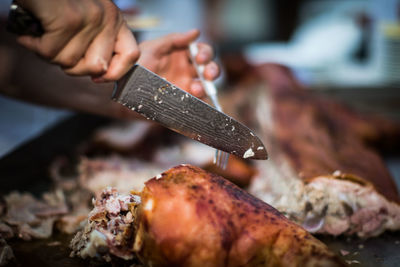 Close-up of person preparing food on barbecue grill