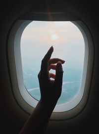 Man seen through airplane window