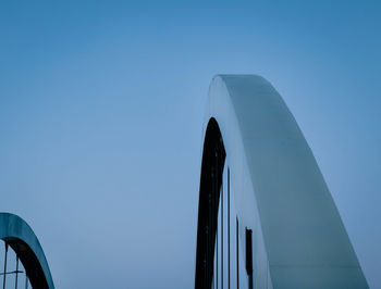 Low angle view of bridge against clear blue sky