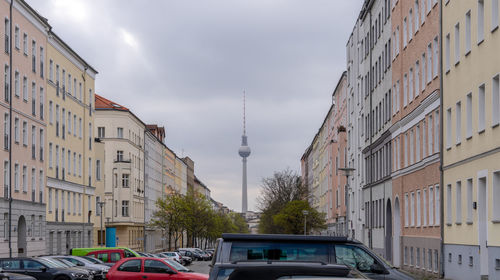 Buildings in city against cloudy sky