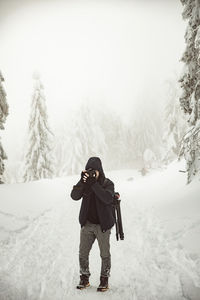 Man standing on snow covered land