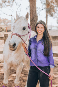 Portrait of smiling young woman standing outdoors