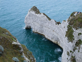 High angle view of rocks on sea shore