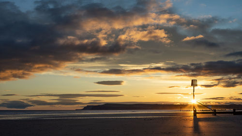 Scenic view of beach against sky during sunset