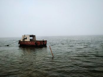 Ship in sea against clear sky