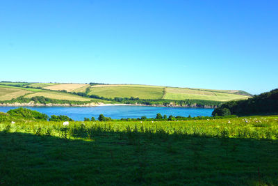 Calm lake against countryside landscape