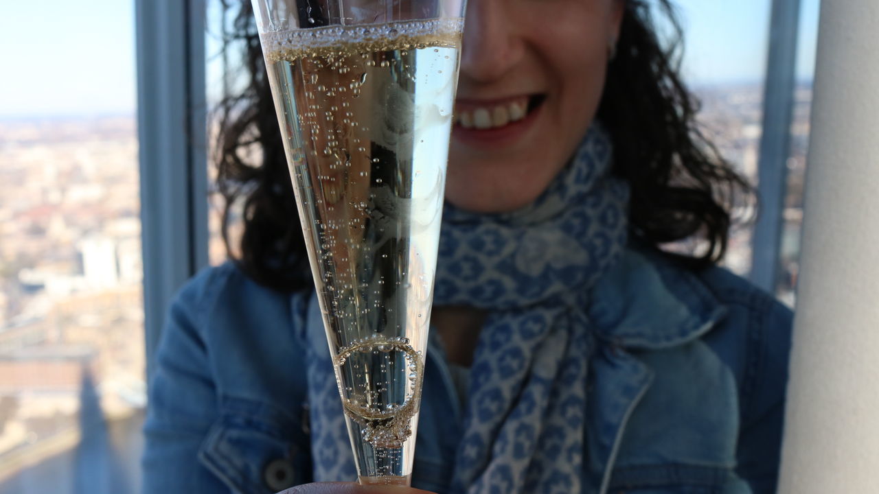 real people, one person, holding, smiling, focus on foreground, water, day, outdoors, close-up, sky