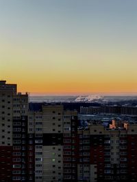 Cityscape against sky during sunset