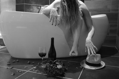 Drunk woman in bathtub at home