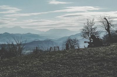 Scenic view of mountains against cloudy sky