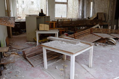 Empty chairs and table in abandoned house