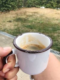 Midsection of person holding coffee cup