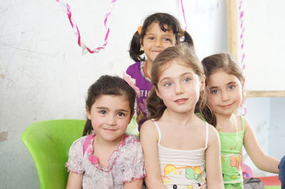 Portrait of cute smiling girls at home