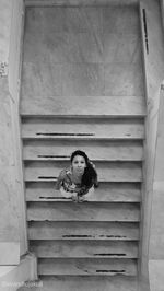 Portrait of woman sitting on staircase
