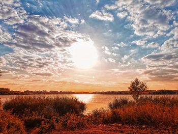 Scenic view of lake against sky during sunset