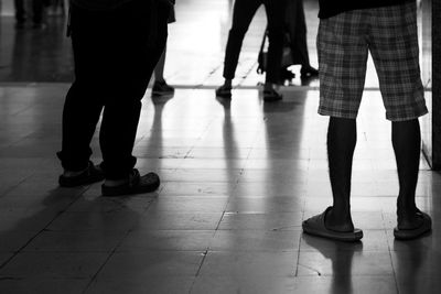 Low section of people walking on street