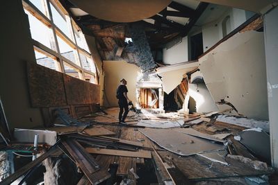 Young man walking in abandoned house