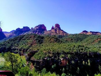 Scenic view of mountains against clear blue sky