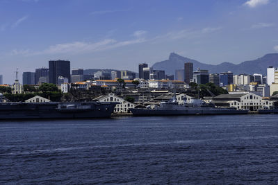 Scenic view of sea by buildings against sky