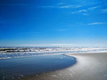 Scenic view of sea against blue sky