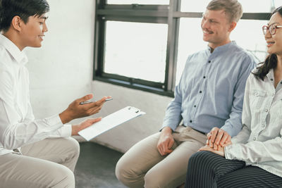 Doctor discussing with couple in hospital