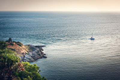 Sailboat sailing in sea against sky