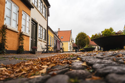 Surface level of road by buildings against sky