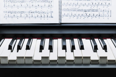 Black and white keys on a electronic piano pulsing an a chord