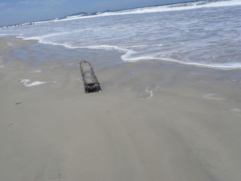 Lifeguard hut on beach against sky