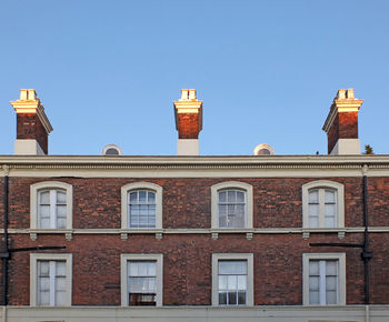 Low angle view of building against clear blue sky