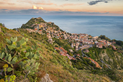 Scenic view of sea and buildings against sky