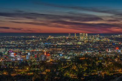 High angle view of illuminated cityscape against sky at night