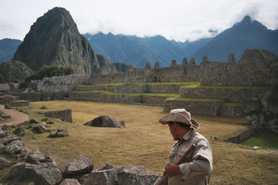 Sanitation worker cleaning field at machu picchu