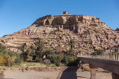 Rock formations on mountain against blue sky