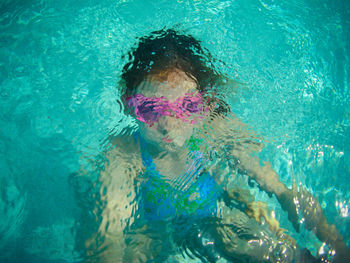 Close-up portrait of girl swimming in pool