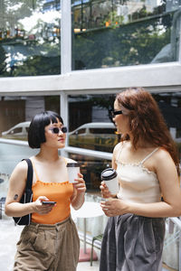 Young woman wearing sunglasses standing outdoors