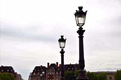 Street light in city against sky