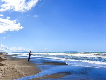 Mature man standing at shore of beach