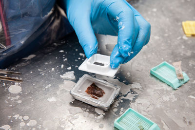 Scientist embedding tissues in paraffin blocks for sectioning. pathology laboratory. 