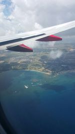 Cropped image of airplane over sea