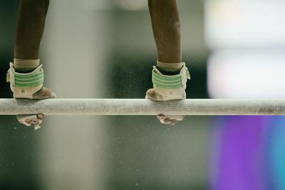 Cropped hands holding horizontal bar