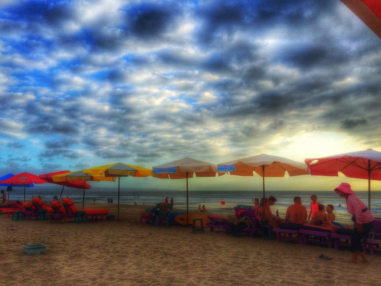 sky, cloud - sky, cloudy, cloud, multi colored, weather, built structure, architecture, overcast, dramatic sky, beauty in nature, scenics, sunset, water, nature, tranquility, beach, building exterior, outdoors, tranquil scene